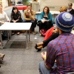 Group of people talking in a circle.